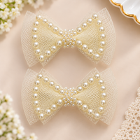 White Dahlia pearl outline bow hair clips Off White